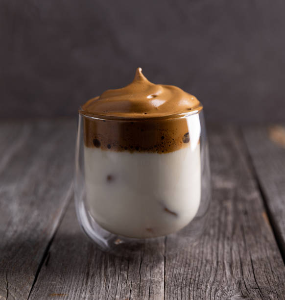 istock Keto dalgona whipped coffee with milk in a glass on rustic wooden background. 1219329369