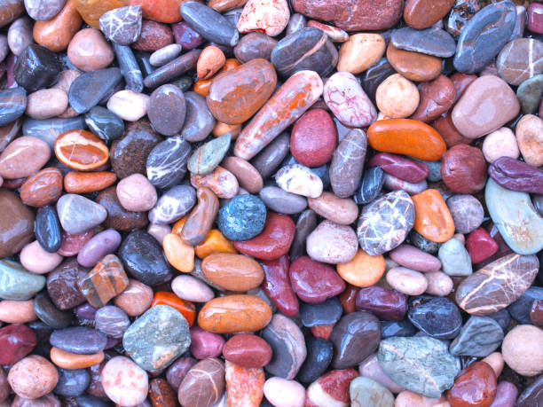 A variety of coloured beach pebbles piled together, nice background for phones and desktop computer wallpapers.