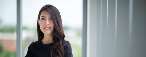 istock Headshot young lady standing in office 1219330334