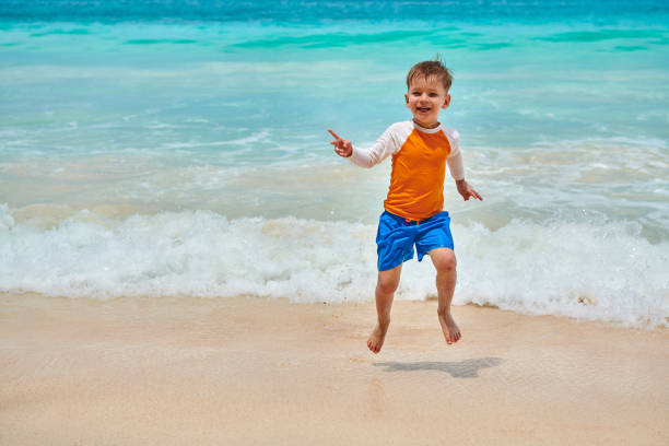 istock Three year old toddler boy running on beach 1219330647