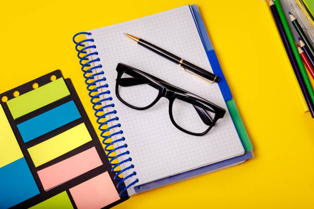 istock Creative office concept with colorful supplies on yellow table 1219334108