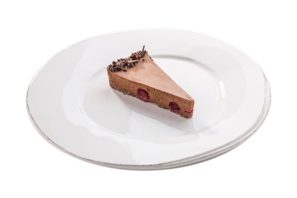 istock Slice of chocolate mousse cake on white plate isolated on white background 1219335087