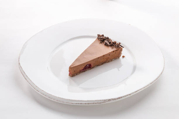 istock Slice of chocolate mousse cake on white plate isolated on white background 1219335105