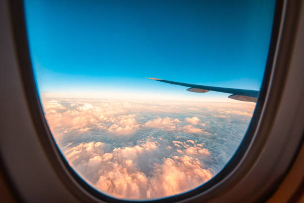 istock Silhouette wing of an airplane at sunset view through the window. 1219335251