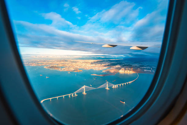 istock Silhouette wing of an airplane at sunset view through the window. 1219335256