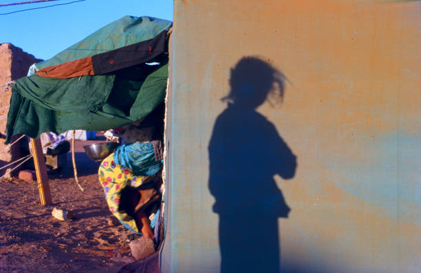 Shadow of a girl in the Sahrawi refugee camps in Algeria Shadow of a girl reflected in the haima at sunrise in the Sahrawi refugee camps in Algeria refugee camp stock pictures, royalty-free photos & images