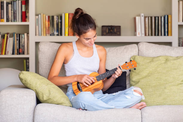 istock young girl playing ukulele 1219335635
