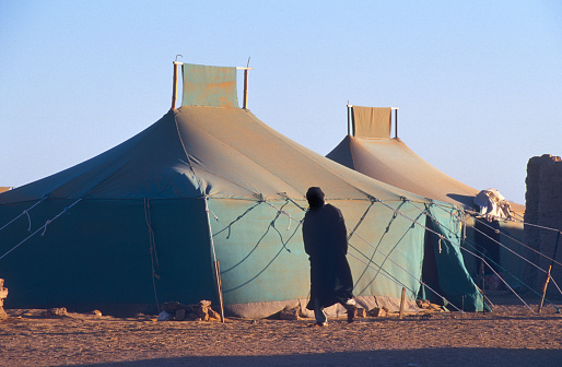 Foot of a barefoot child in the desert sand in the Sahrawi refugee camps in Algeria