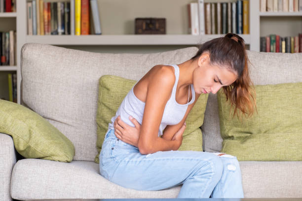 istock young girl with stomach ache 1219335902