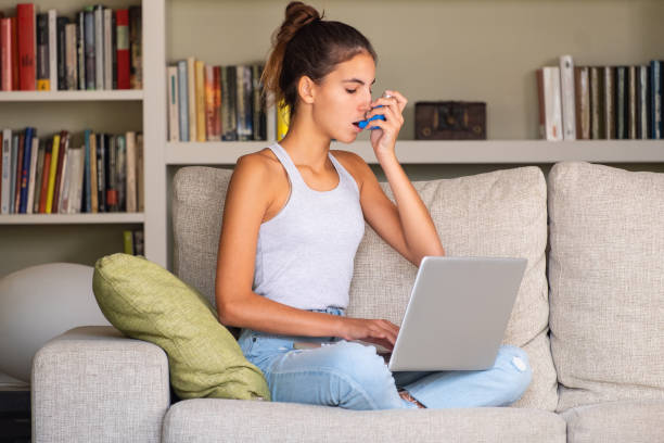 istock young girl having an asthma attack and using an inhaler 1219336129