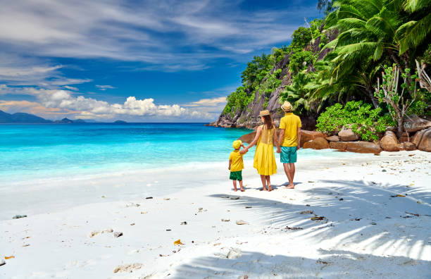 Family with three year old boy on beach. Seychelles, Mahe.