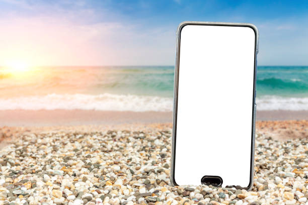 istock Phone with insulation on the beach and sea. 1219339016