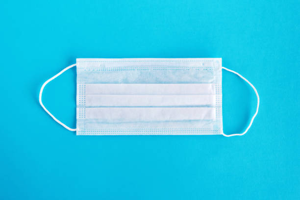 istock Medical face mask on blue background. 1219339391