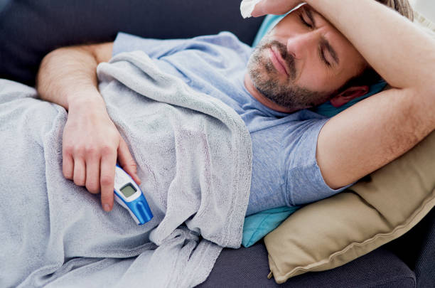 istock Man with high temperature staying at home 1219344514
