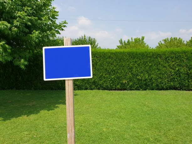istock Post with clean sign, with space to write, in the middle of nature. Horizontal image with a green domain. Template to print written concepts about nature, parks, natural spaces. Mockup. Clean. 1219345219