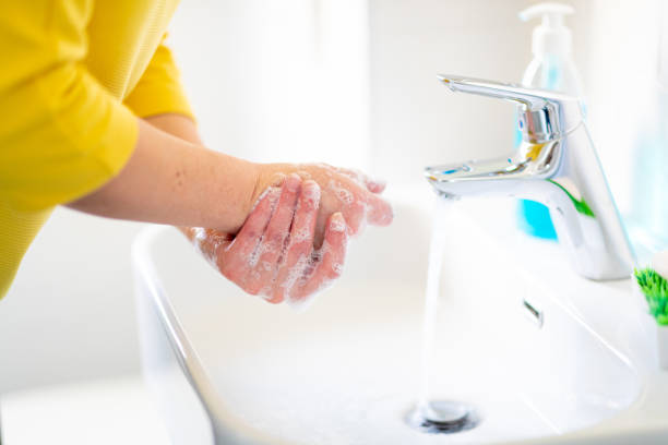 istock Washing hands and rubbing soap sud in bathroom sink 1219346309
