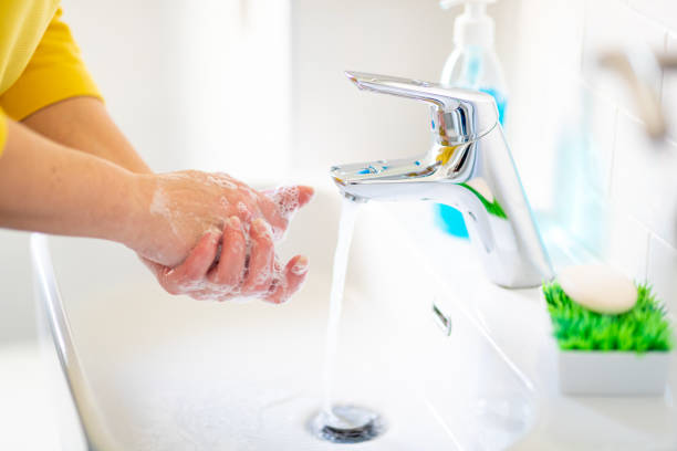 istock Washing hands under water in the bathroom 1219346328