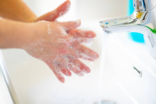 istock Washing hands and rubbing soap sud between fingers 1219346335