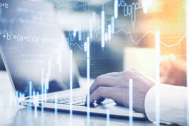 istock Businessman hands using laptop with glowing business chart. 1219346367