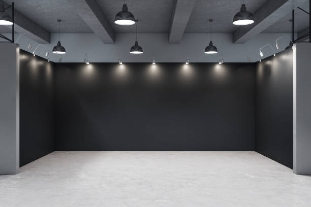 istock Gallery interior with empty black wall and concrete floor. 1219346553