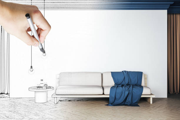 istock Hand with pen drawing living room interior 1219346597