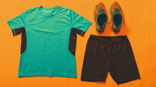 istock Sport clothes flat lay on orange background 1219346810