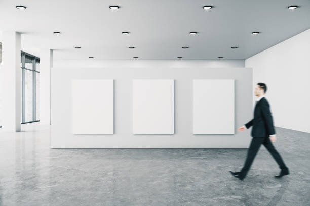 istock Businessman in gallery with billboard 1219347787
