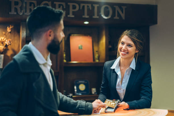 istock Businessman in hotel paying at checkout 1219348652