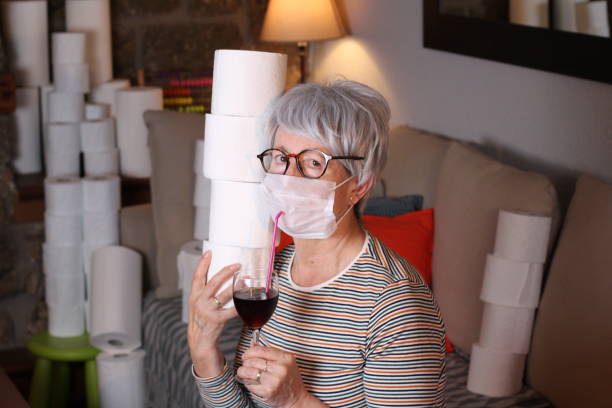 istock Senior woman drinking cocktail during pandemic 1219349032