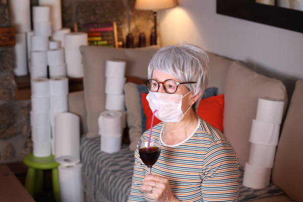 istock Senior woman enjoying a cocktail during quarantine 1219349061