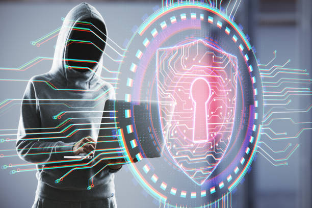 istock Hacker holding laptop with antivirus shield hologram 1219350961