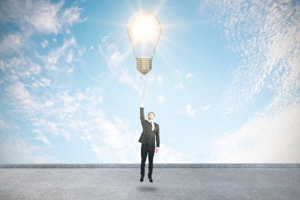 istock Businessman holding light bulb 1219350997