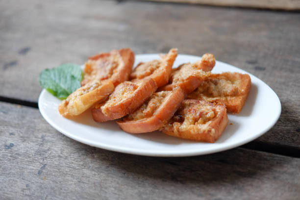 istock Fried Bread with Minced Pork Spread on a plate, placed on a wooden floor 1219351047