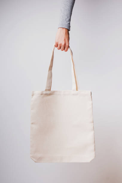 istock Woman's hand holds blank cotton eco tote bag, 1219352254