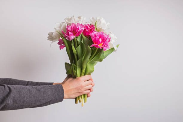 istock Man holding a bouquet with tulip flowers 1219352260
