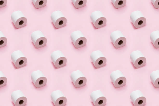 istock Rolls of white toilet paper on pink background. Creative minimalist pattern. 1219352301