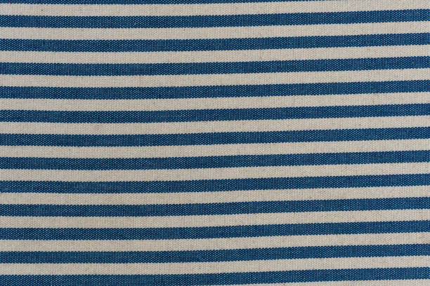istock Nautical textile texture for background. Close up of a marine textile texture with blue and white stripes. 1219352553