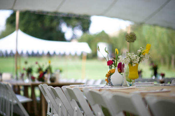 istock Marquee Tent Wedding Reception Colourful Flower Arrangement 1219355439
