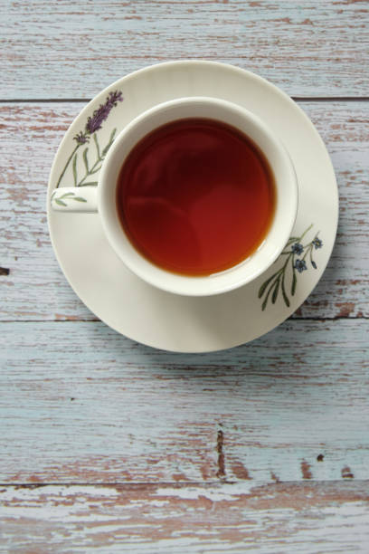 istock Top view of classic ceramic mug with red tea on a wooden table with copy space 1219355463