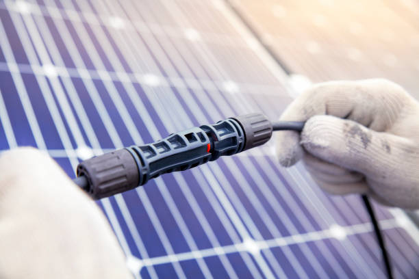 technician connecting the electric wire from solar panels generate, renewable energy clean and good environment. - order repairing telephone change imagens e fotografias de stock