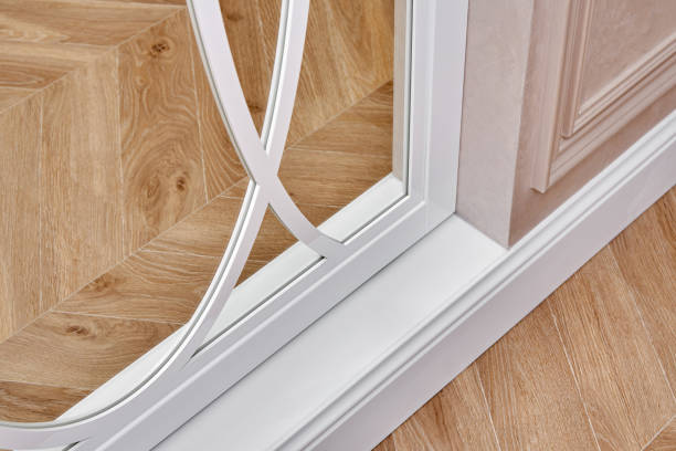 istock Sliding mirror wardrobe doors with overlays decor. White sliding mirror wardrobe on parquet background 1219355907