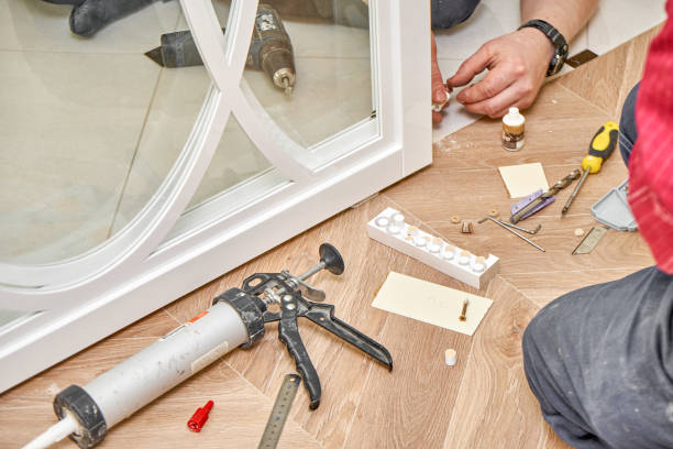 istock Sliding glass doors repair. Worker install end cap. White sliding glass doors with overlays decor 1219356802