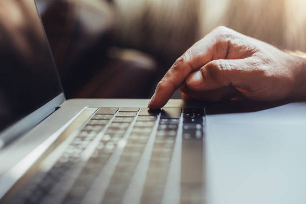 istock A man shopping by using laptop computer at home. Male hand typing on laptop keyboard in office. Businessman, student, work from home, distance education, online learning, studying concept 1219357372