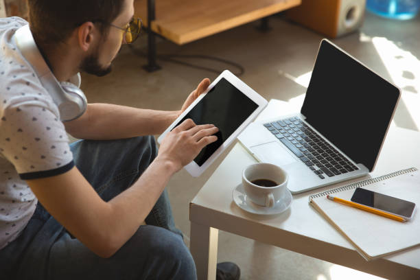 istock Man working from home during coronavirus or COVID-19 quarantine, remote office concept 1219360190