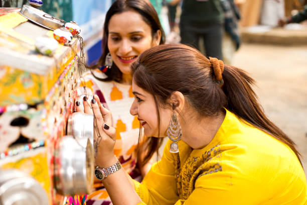 Happy Indian women watching movie through bioscope at Surajkund Mela