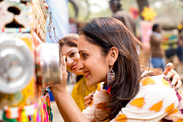istock Women looking into bioscope at Surajkund Mela 1219361287