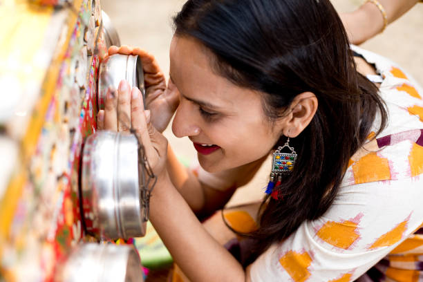 istock Women looking into bioscope at Surajkund Mela 1219361448