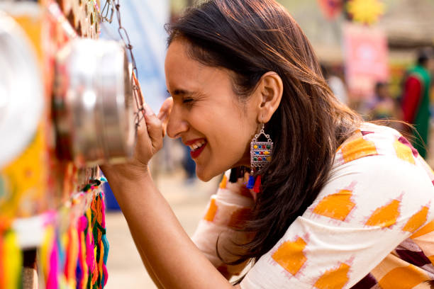 istock Women looking into bioscope at Surajkund Mela 1219362066