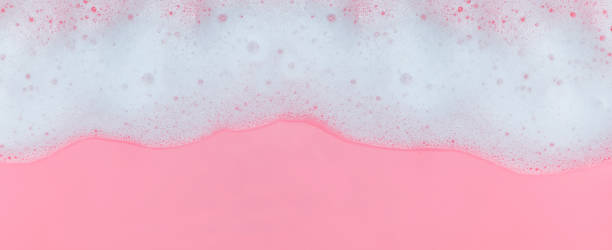 istock White soap foam with bubbles on pink background 1219362159