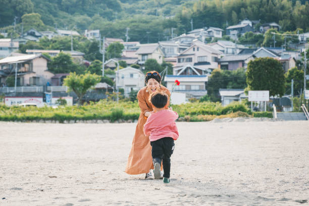istock Boy handing mother a carnation flower 1219363052
